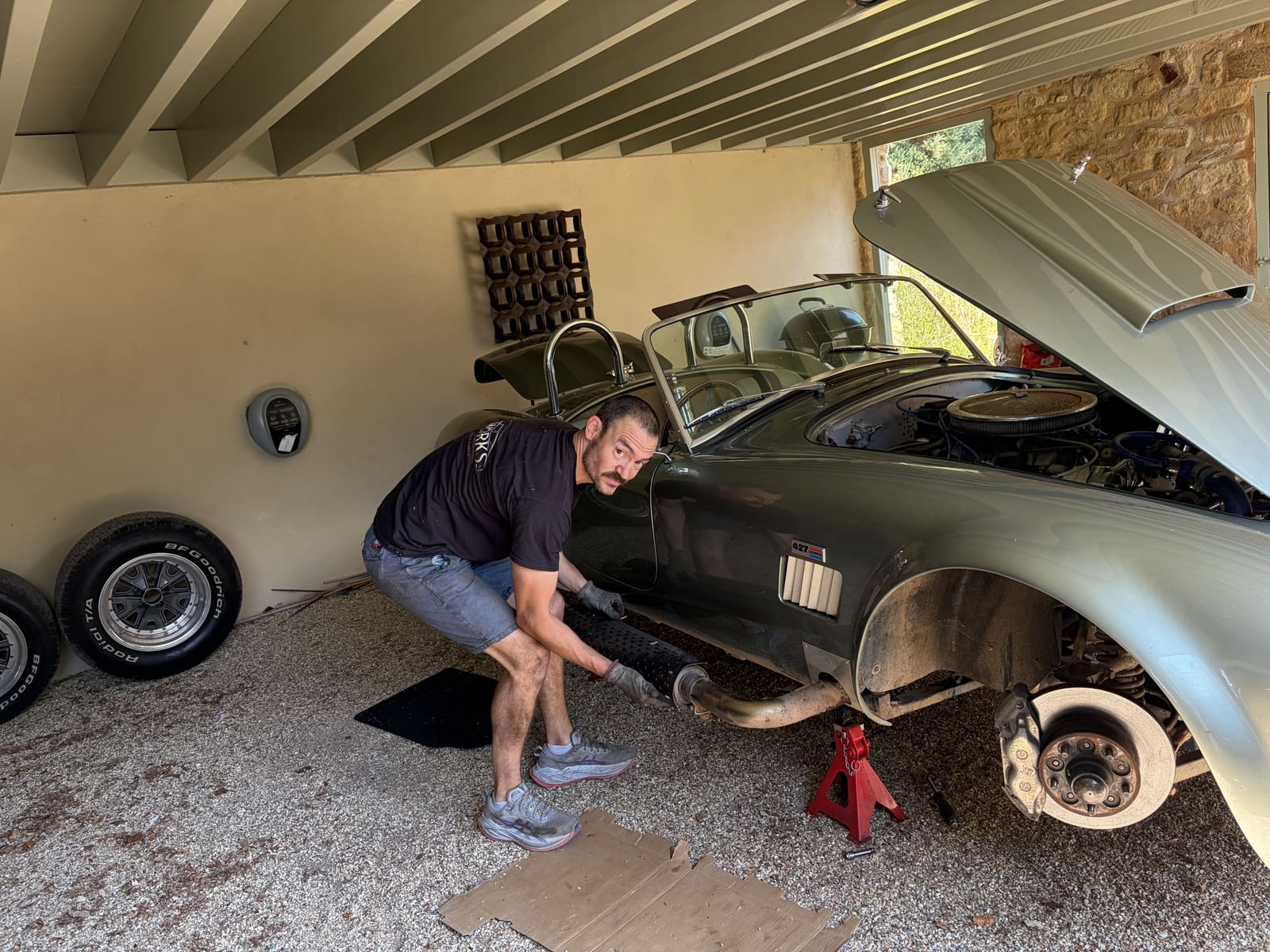 SL Works technician working beneath a Shelby Cobra 427